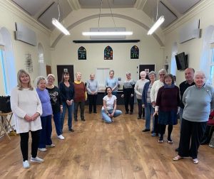 Line dancers facing the front in Eggborough village hall.