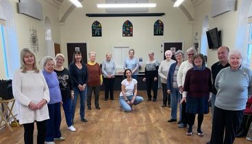 Line dancers facing the front in Eggborough village hall.