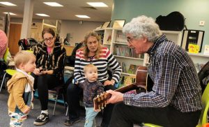 Martyn the Music Man plays his guitar for children at Thirsk Library.