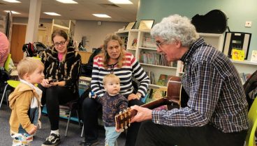 Martyn the Music Man plays his guitar for children at Thirsk Library.