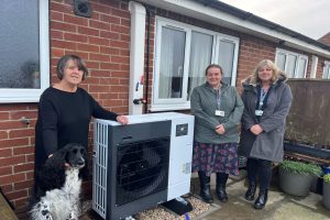 Julie, Polly, Joanne and Helen standing in front of an air-source heart pump.